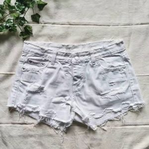 White distressed jean shorts.